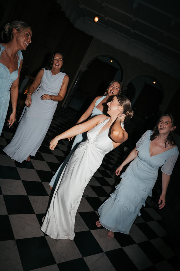 Evening Celebrations Bride dancing with her bridesmaids during the evening wedding celebrations.