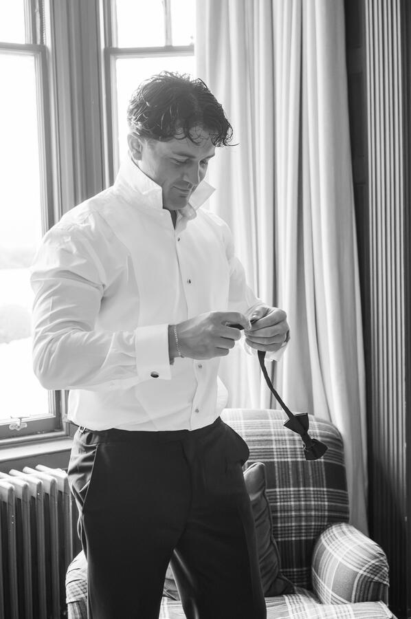 Groom getting ready Groom getting his bow tie on for his wedding day in Scotland.